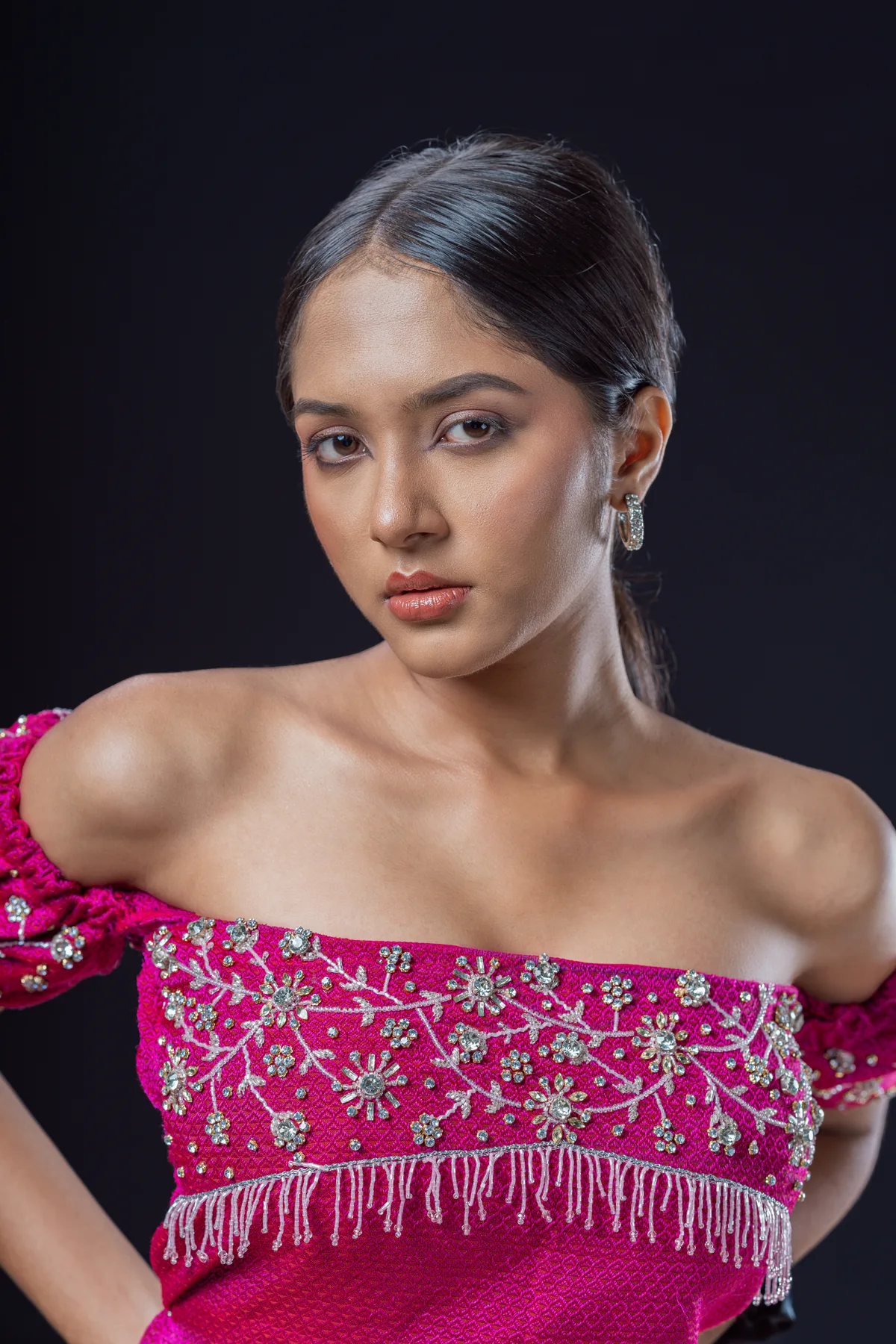 Studio portrait in a pink embellished dress